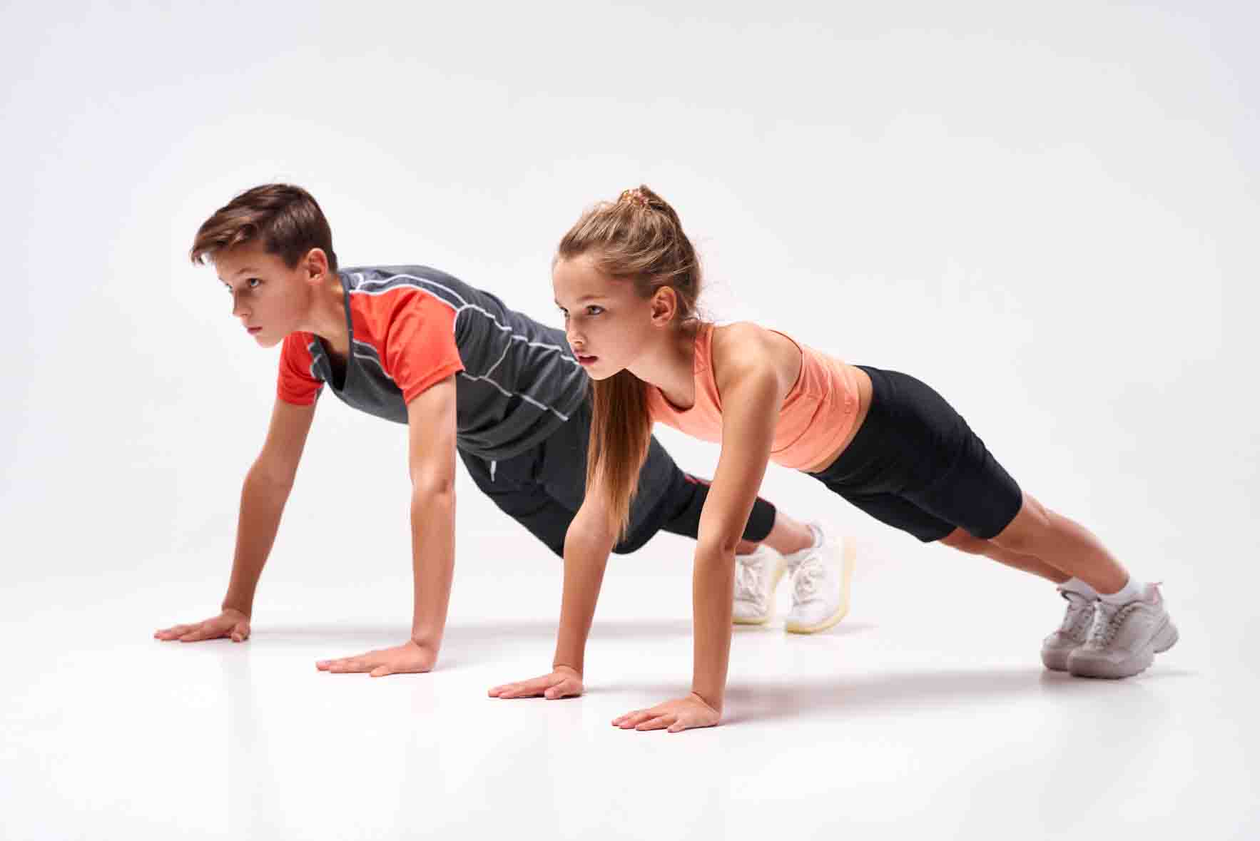 Full-length,Shot,Of,Teenage,Boy,And,Girl,Engaged,In,Sport,